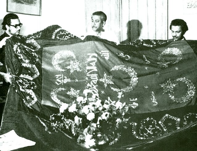 Sheikh Mujibur Rahman receives an embroidered "ghilaf" as gift at the mausoleum of Hazrat Abdul Quader Jilani (R).